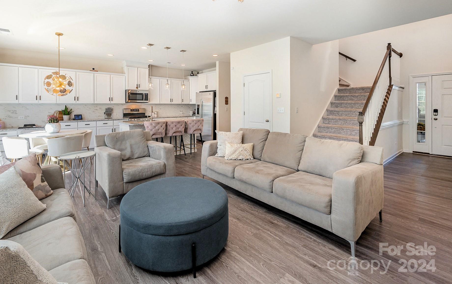 641 Amber Meadows Way Tega Cay, SC 29708 - Photo 6 of 28 a living room with furniture and a wooden floor