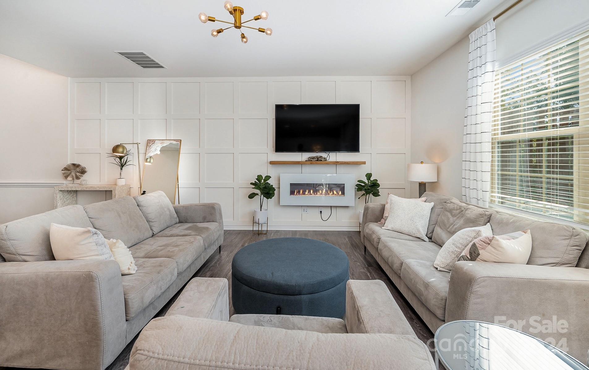 641 Amber Meadows Way Tega Cay, SC 29708 - Photo 7 of 28 a living room with furniture and a flat screen tv