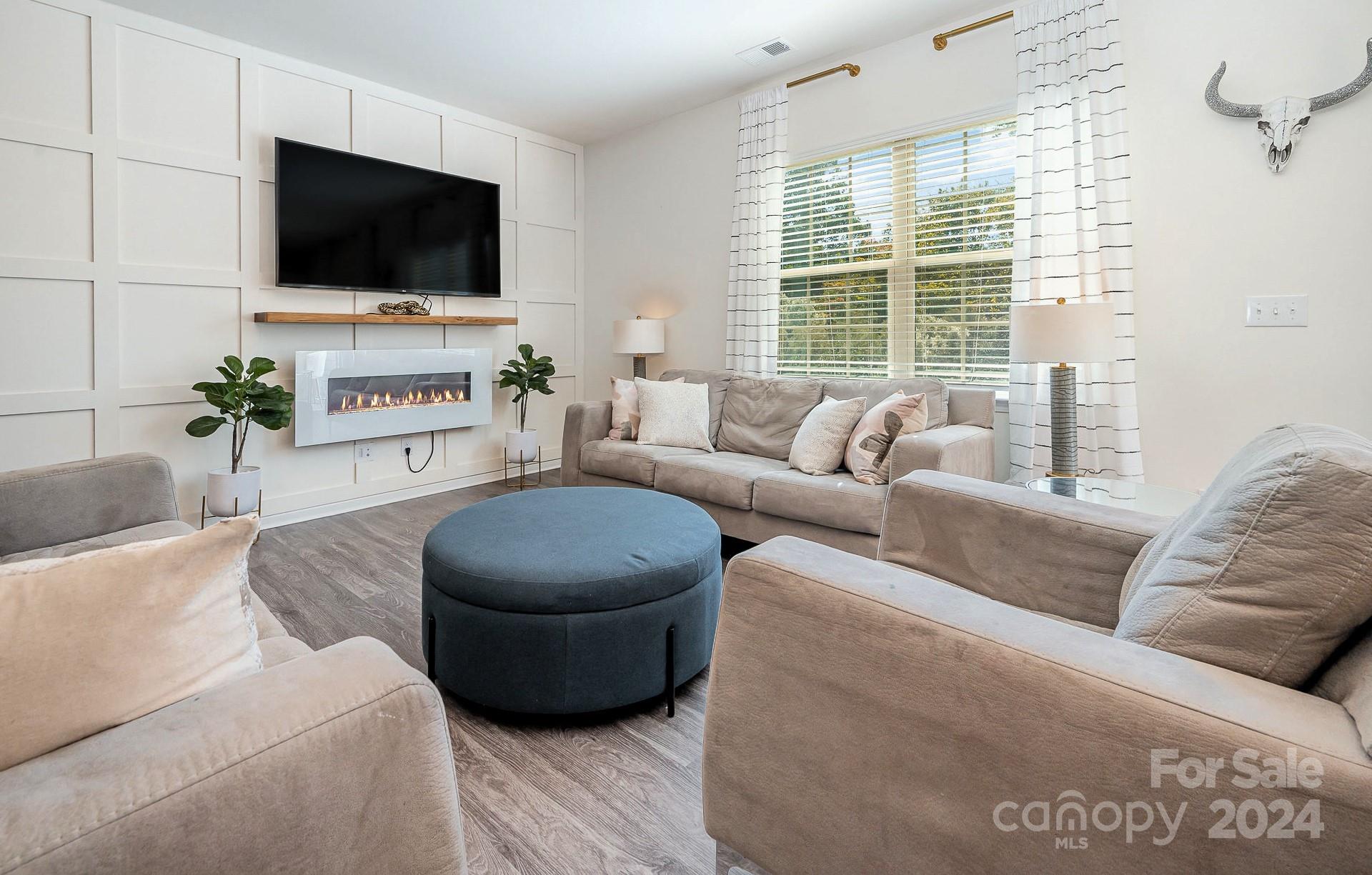 641 Amber Meadows Way Tega Cay, SC 29708 - Photo 8 of 28 a living room with furniture and a flat screen tv