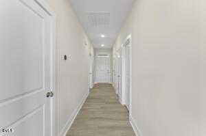2760 River Meadow Spring Hope, NC 27882 - Photo 30 of 42 a view of a hallway with wooden floor and staircase