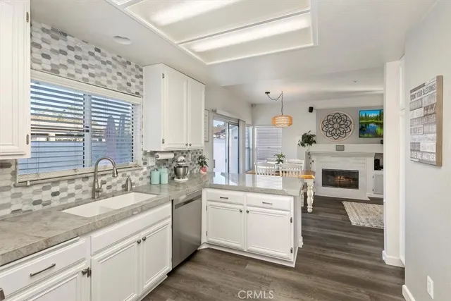 a kitchen with a sink cabinets and wooden floor