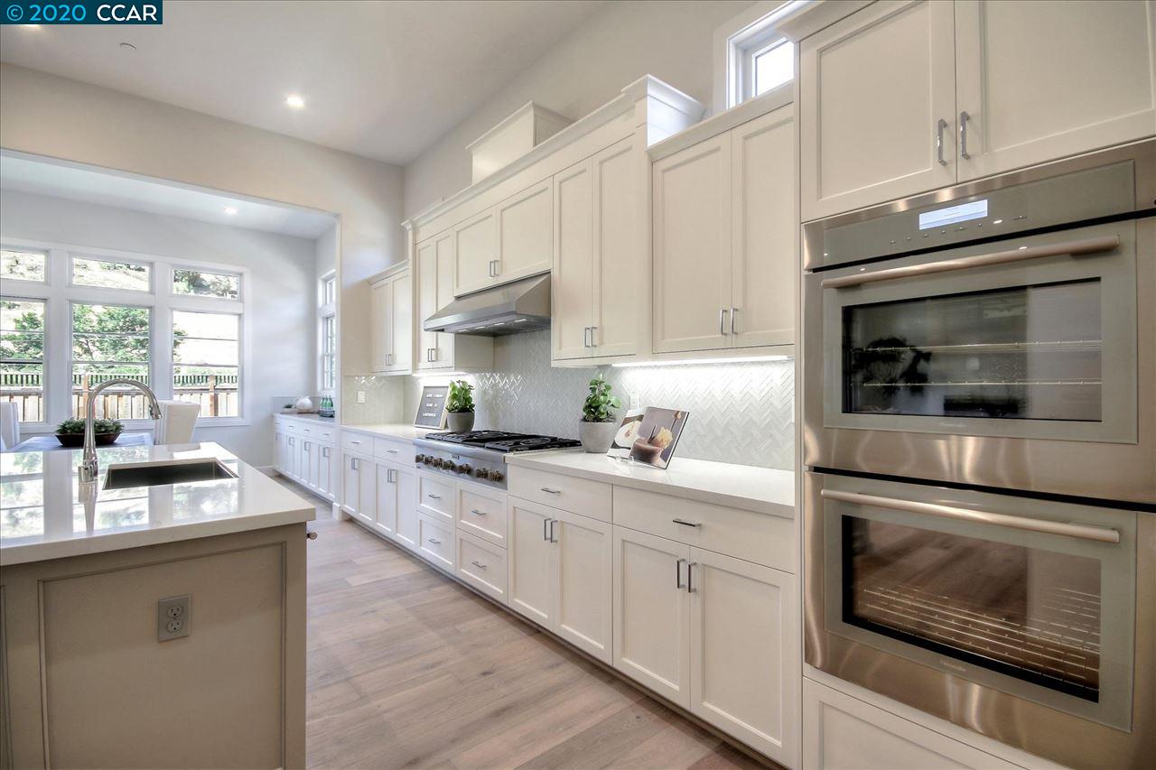 a kitchen with granite countertop white cabinets stainless steel appliances and sink