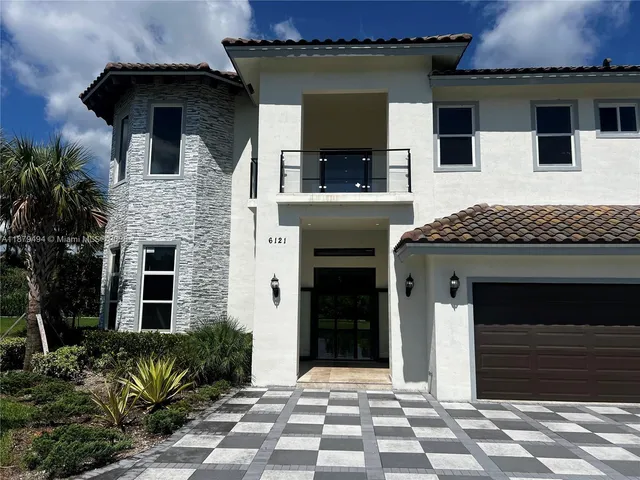 a large kitchen with a large counter top stainless steel appliances and cabinets