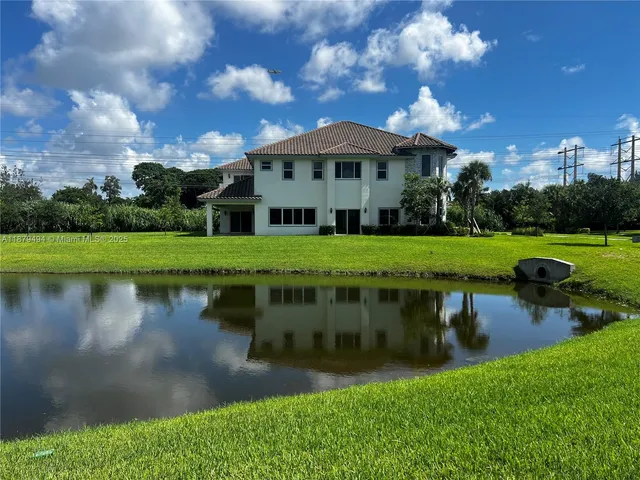 a front view of a house with a lake view