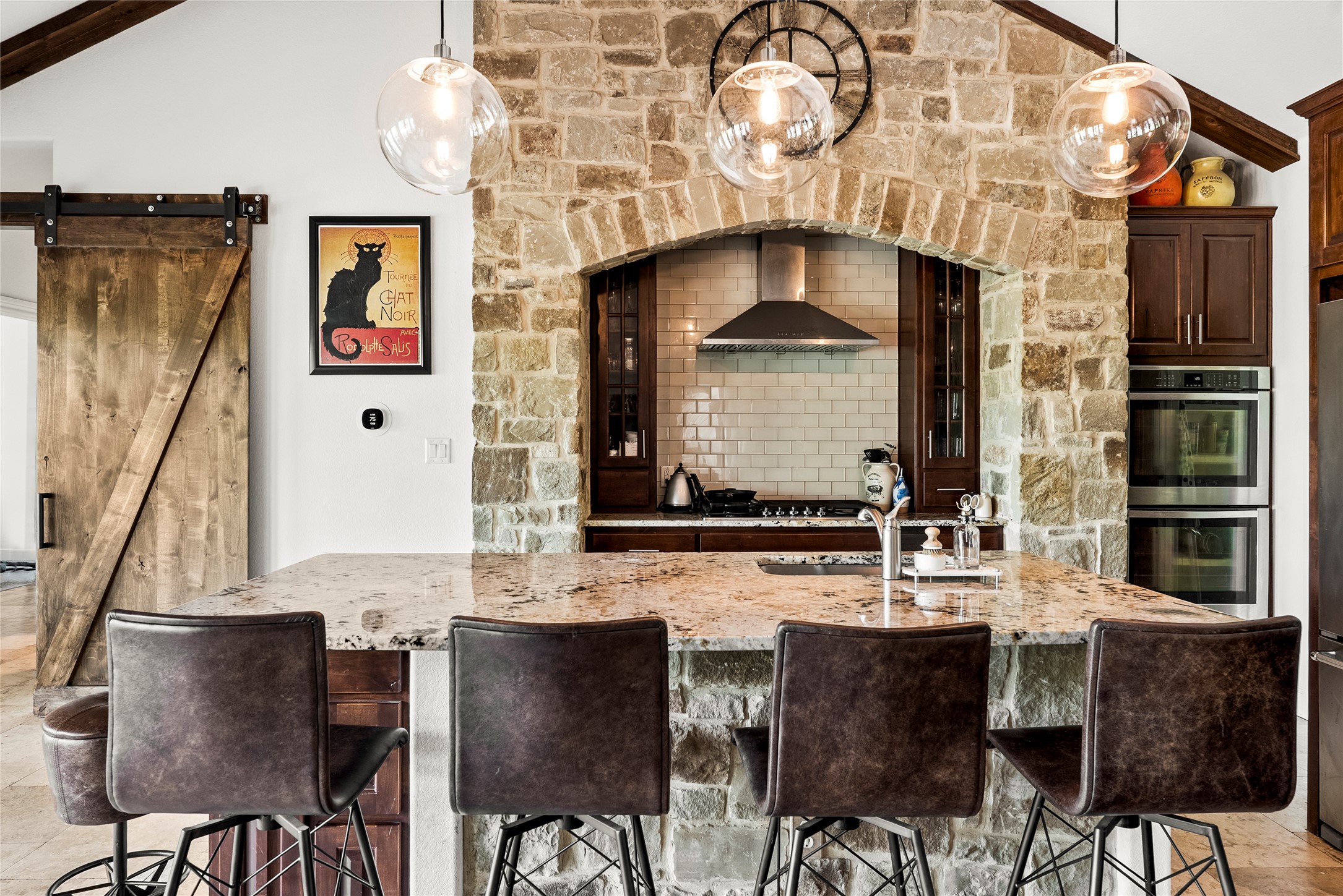 23224 Nameless Road Leander, TX 78641 - Photo 12 of 23 A spacious kitchen offers a large granite island and built-in appliances, perfect for entertaining.