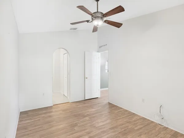 a view of an empty room with a fan