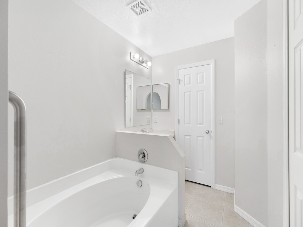2575 12th Square Southwest Vero Beach, FL 32968 - Photo 13 of 31 a bathroom with a bathtub and a shower
