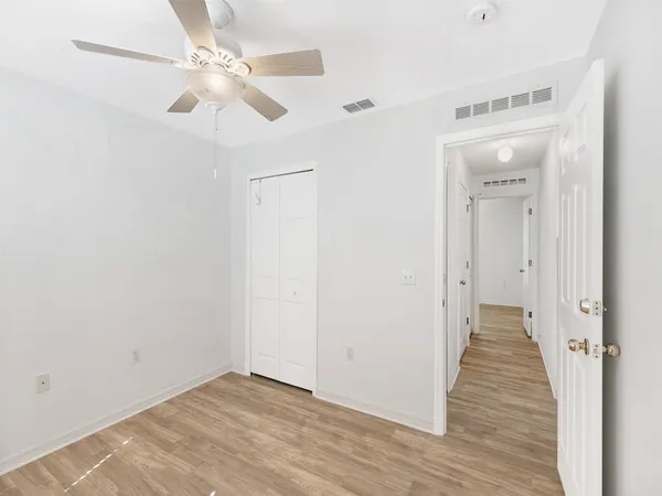 a view of a hallway with wooden floor