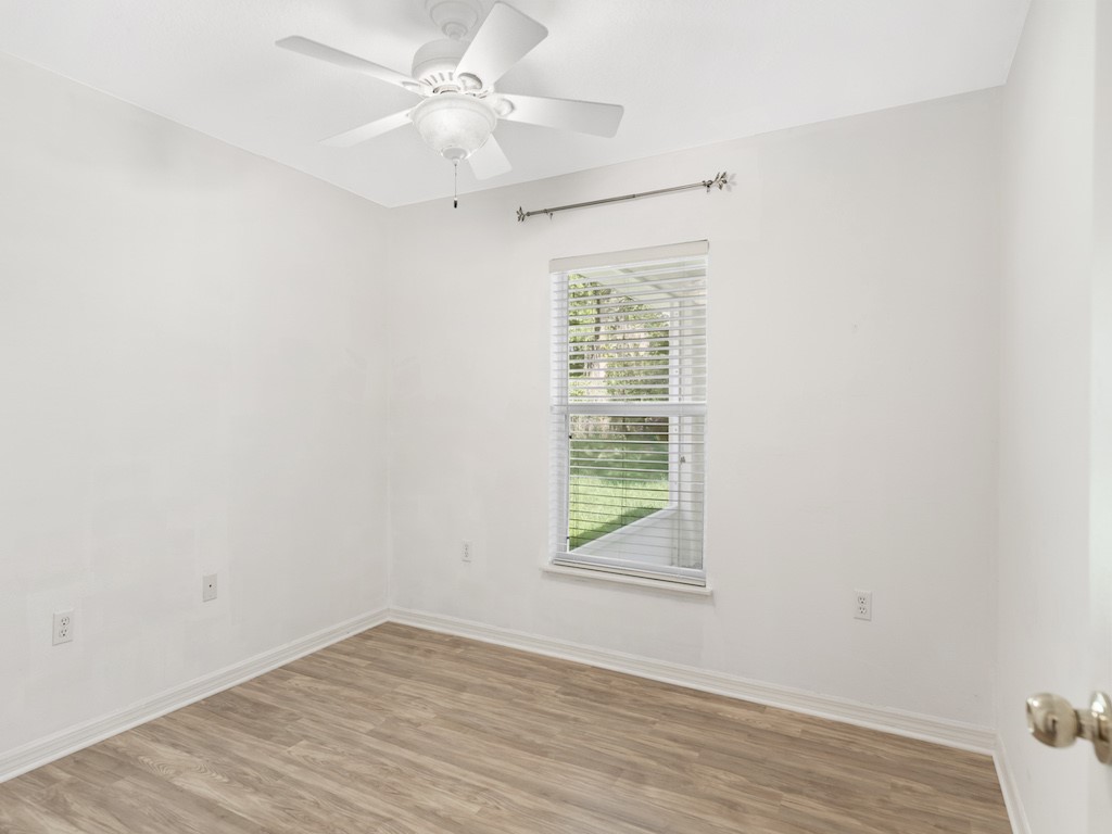 2575 12th Square Southwest Vero Beach, FL 32968 - Photo 19 of 31 an empty room with a window and a ceiling fan