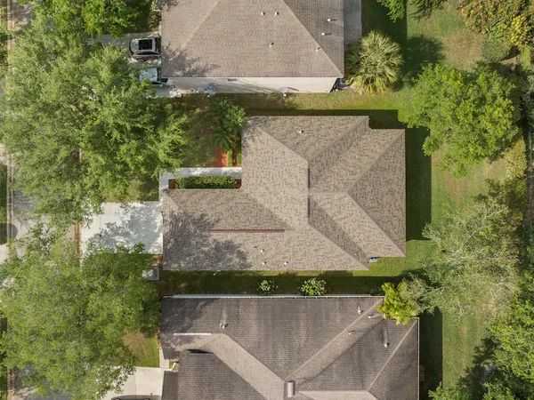 an aerial view of a house with a yard