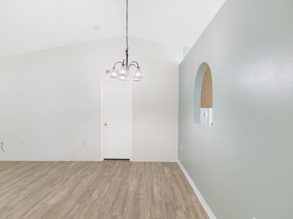 2575 12th Square Southwest Vero Beach, FL 32968 - Photo 7 of 31 a view of a room with wooden floor and chandelier