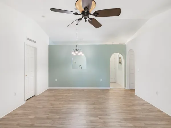 a view of room with window and wooden floor