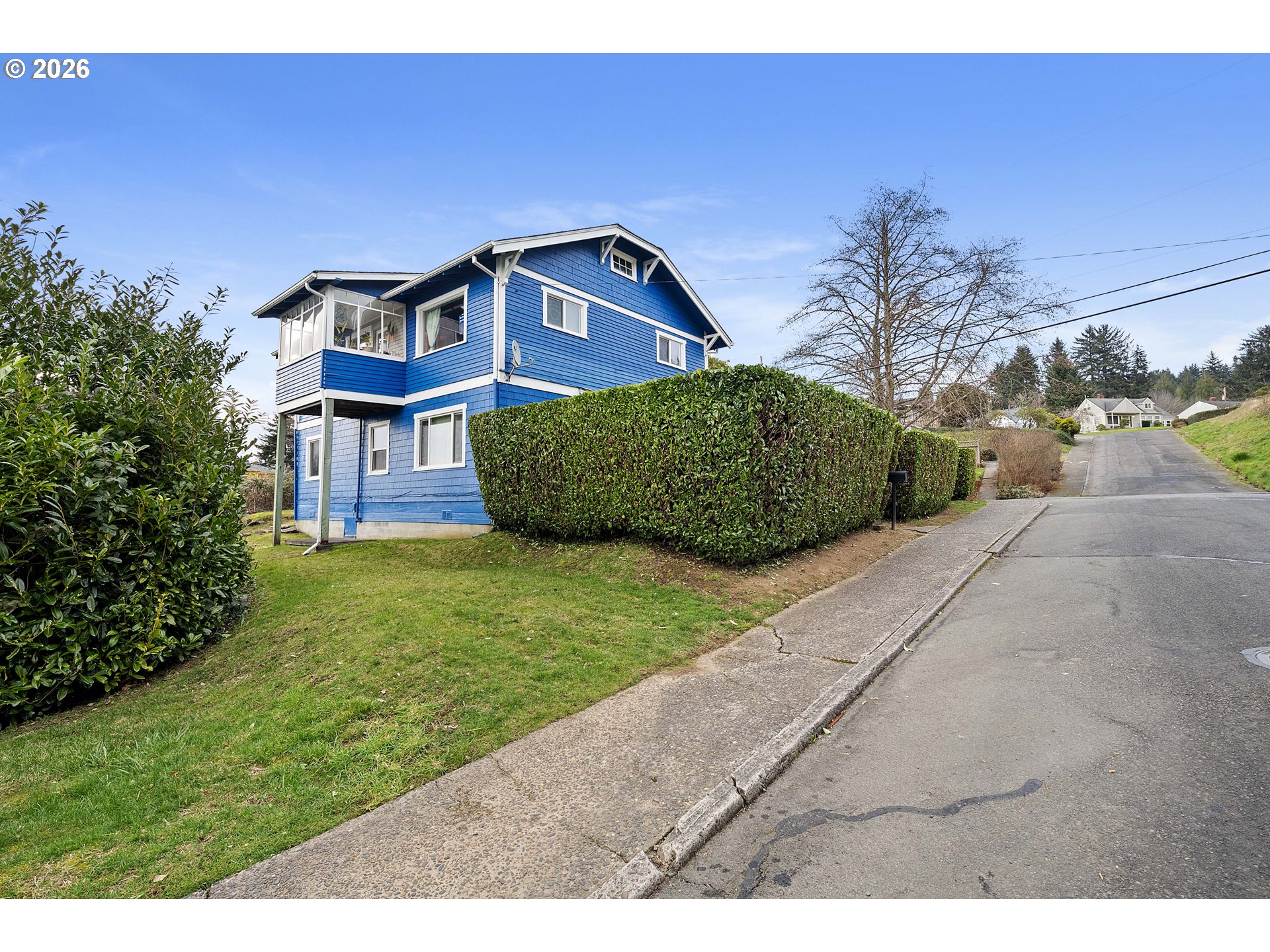 3496 Harrison Avenue Astoria, OR 97103 - Photo 14 of 18 a front view of a house with a garden