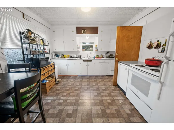 a kitchen with a sink and wooden cabinets