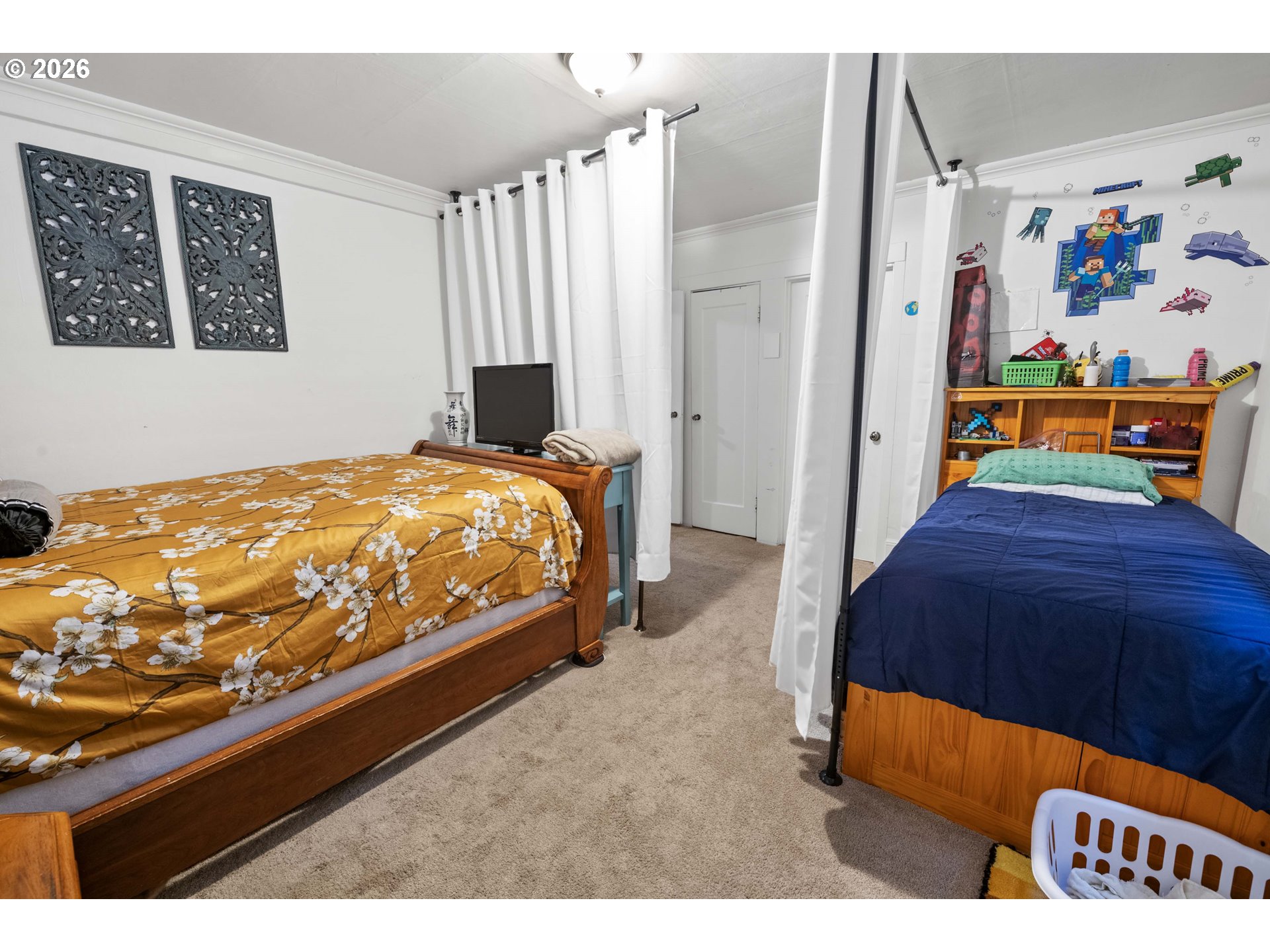 3496 Harrison Avenue Astoria, OR 97103 - Photo 9 of 18 a bedroom with a bed and a painting on the wall