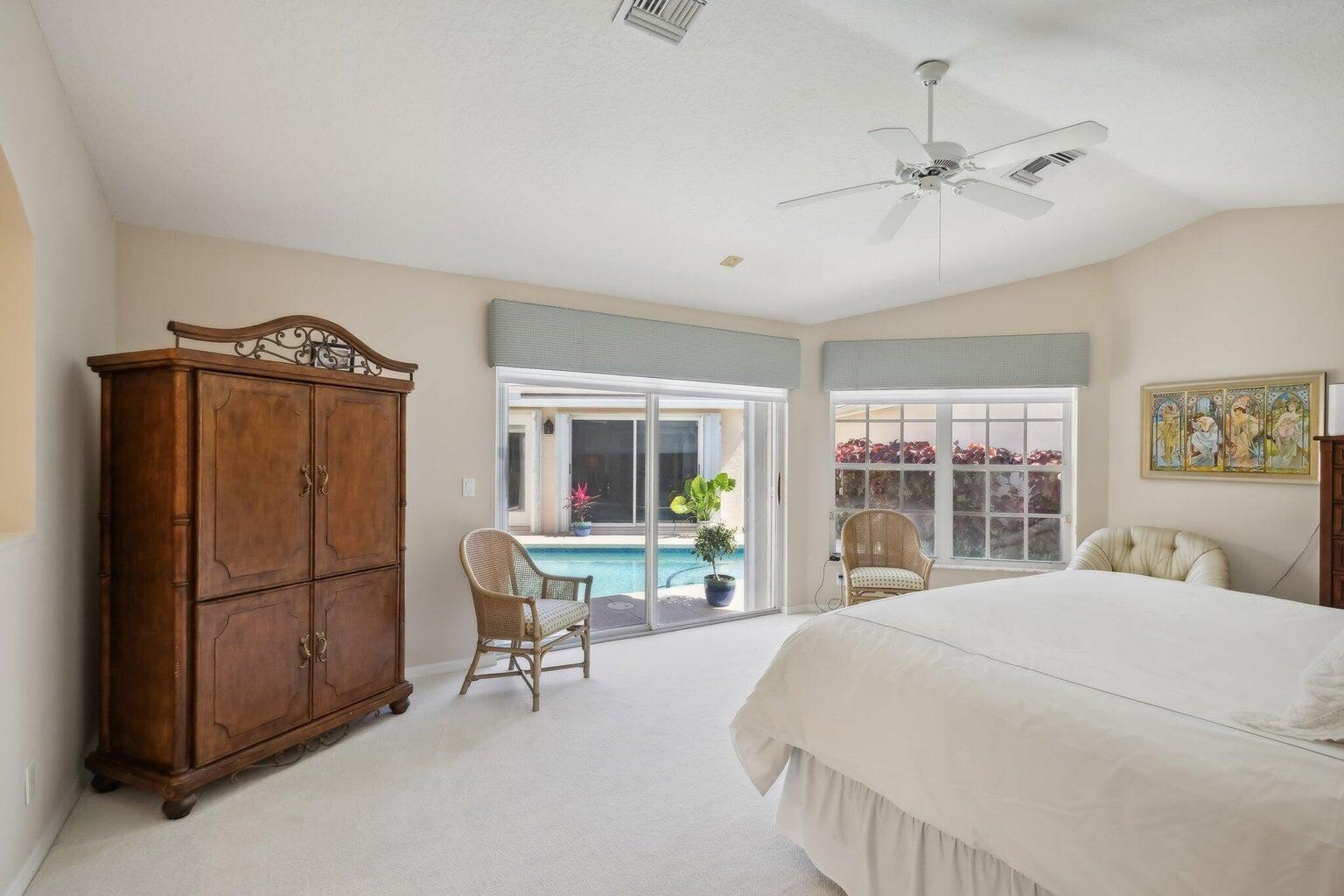 16481 Riverwind Drive Jupiter, FL 33477 - Photo 22 of 49 a bedroom with a bed and a large mirror