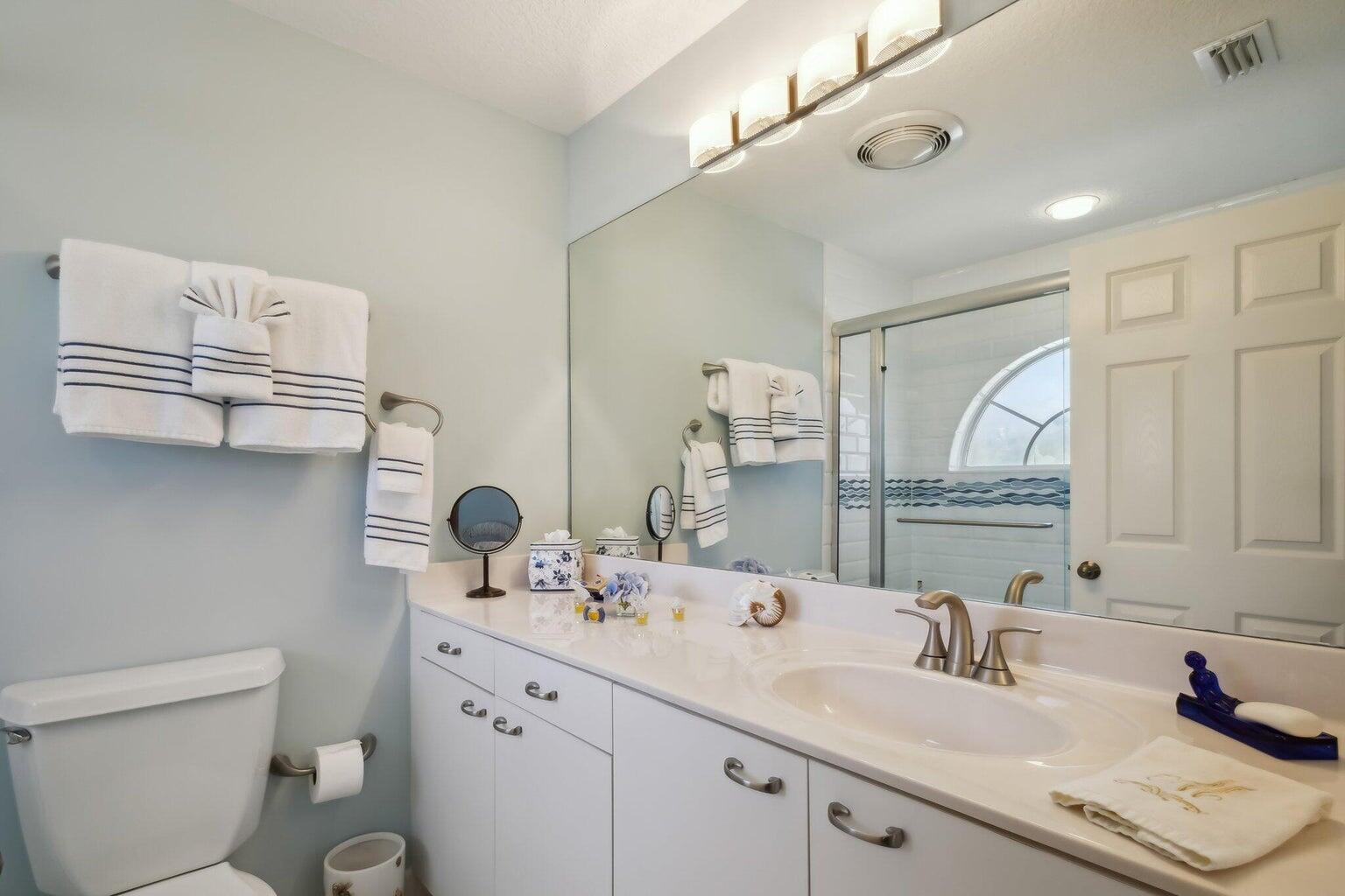 16481 Riverwind Drive Jupiter, FL 33477 - Photo 30 of 49 a bathroom with a sink a toilet and a mirror