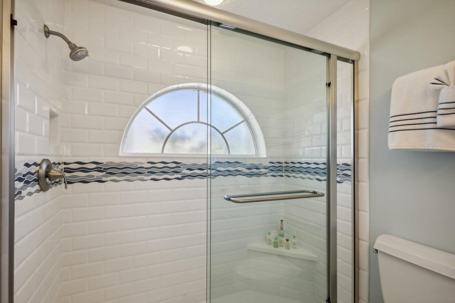 16481 Riverwind Drive Jupiter, FL 33477 - Photo 31 of 49 a bathroom with a granite countertop sink a mirror and shower