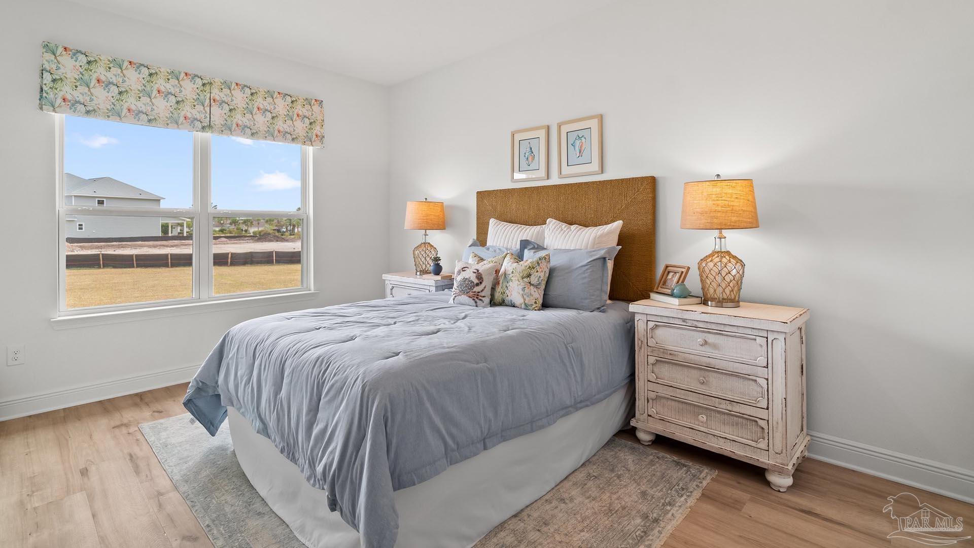 3080 Daybreak Lane Milton, FL 32571 - Photo 12 of 15 a bedroom with a bed and wooden floor