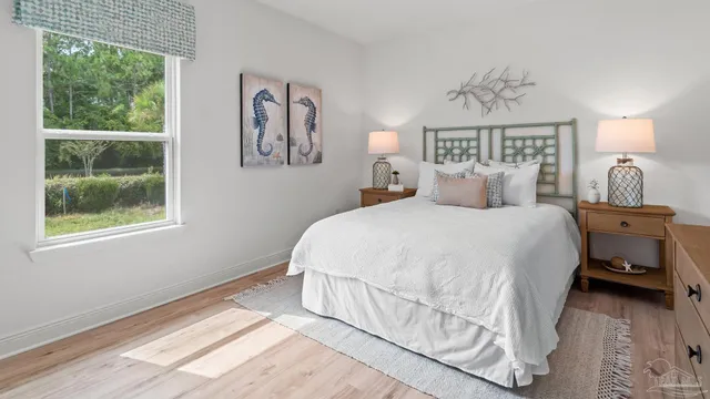 a bedroom with a bed and a painting on the wall