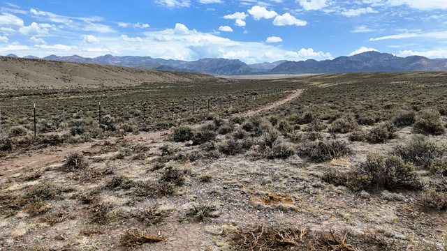 123 East Tbd 5000 Road North Panguitch, UT 84759 - Photo 29 of 54 Expansive undeveloped land featuring a natural landscape, distant mountain ranges, a clear blue sky, and a visible dirt path