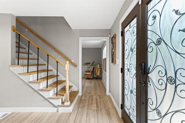 a view of a entryway with wooden floor and stairs