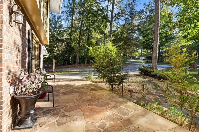 a view of a patio with table and chairs and potted plants