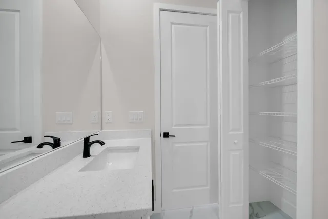 an empty room with a window and a ceiling fan