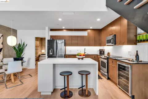 a kitchen with appliances a sink and cabinets