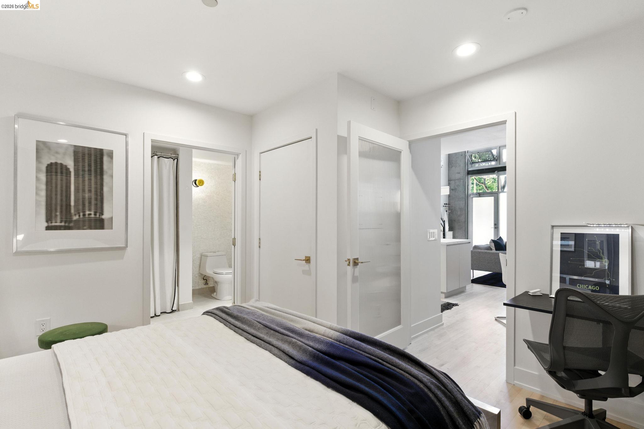 311 Oak Street, Unit 102 Oakland, CA 94607 - Photo 18 of 52 a bedroom with a bed and a flat screen tv