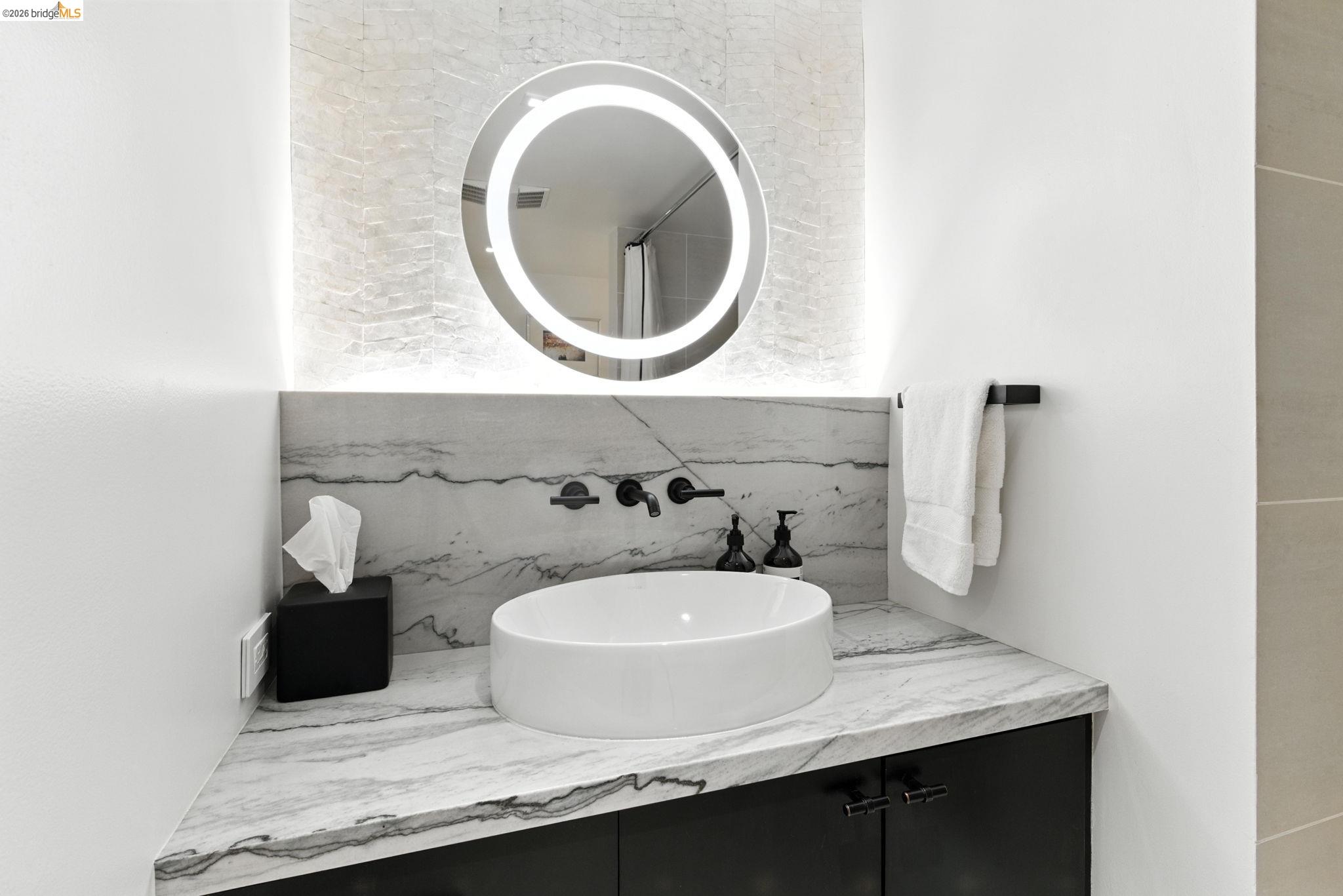 311 Oak Street, Unit 102 Oakland, CA 94607 - Photo 22 of 52 a bathroom with a sink and a mirror