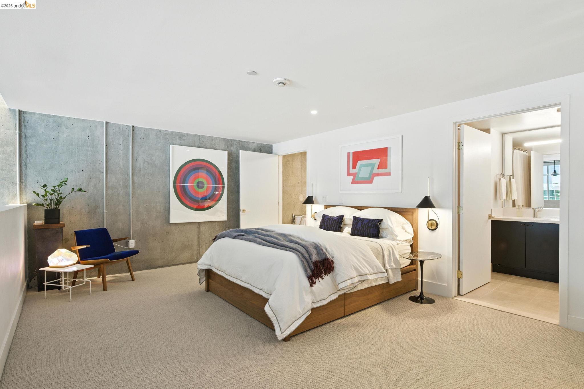 311 Oak Street, Unit 102 Oakland, CA 94607 - Photo 24 of 52 a bed room with a bed and a chair