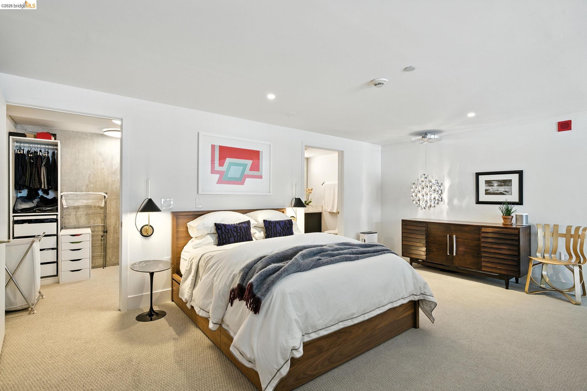311 Oak Street, Unit 102 Oakland, CA 94607 - Photo 26 of 52 a spacious bedroom with a bed and dresser