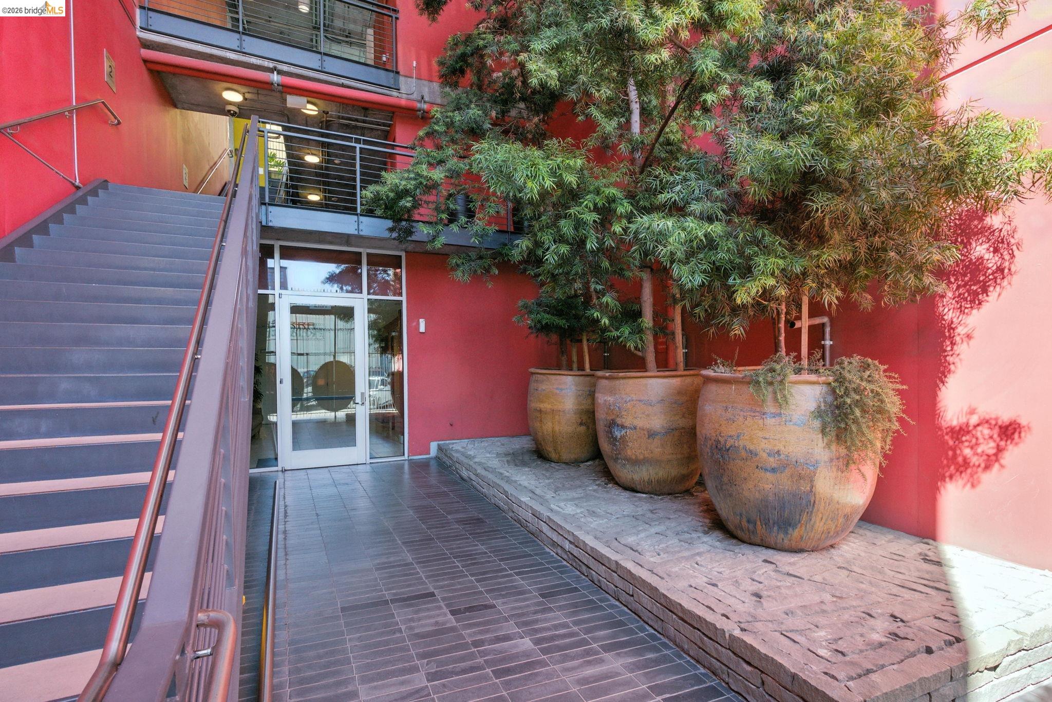 311 Oak Street, Unit 102 Oakland, CA 94607 - Photo 34 of 52 a view of a patio with table and chairs and potted plants
