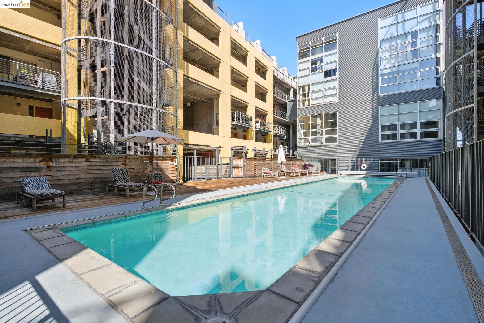 311 Oak Street, Unit 102 Oakland, CA 94607 - Photo 37 of 52 a swimming pool with outdoor seating and yard