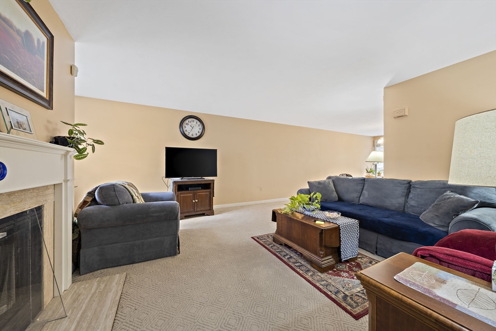 501 Auburn Street, Unit 404 Whitman, MA 02382 - Photo 11 of 35 a living room with furniture and a fireplace