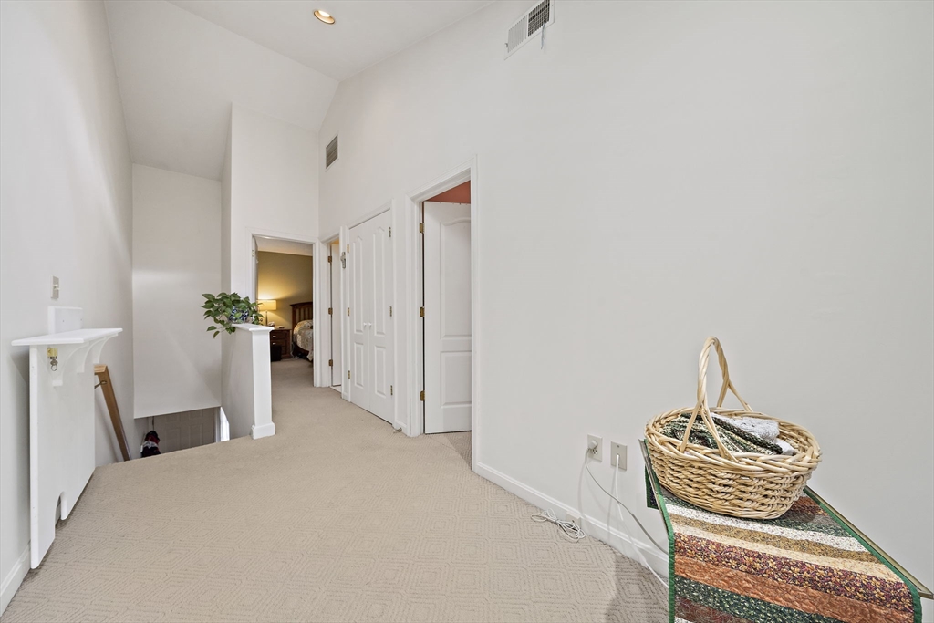 501 Auburn Street, Unit 404 Whitman, MA 02382 - Photo 12 of 35 a bedroom with a bed and a chair