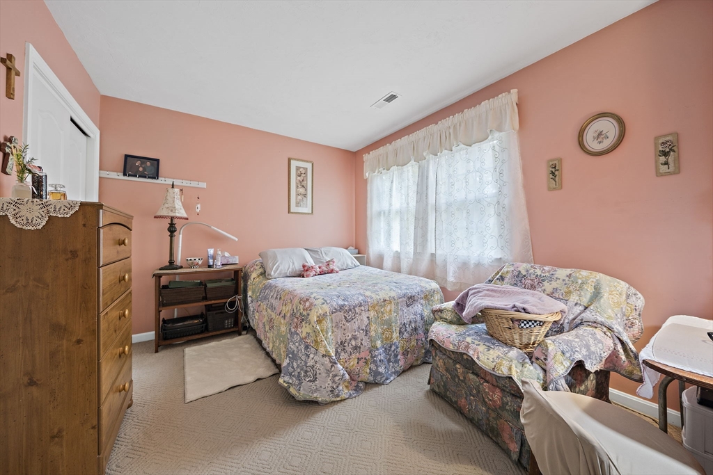 501 Auburn Street, Unit 404 Whitman, MA 02382 - Photo 13 of 35 a bedroom with a bed and a couch