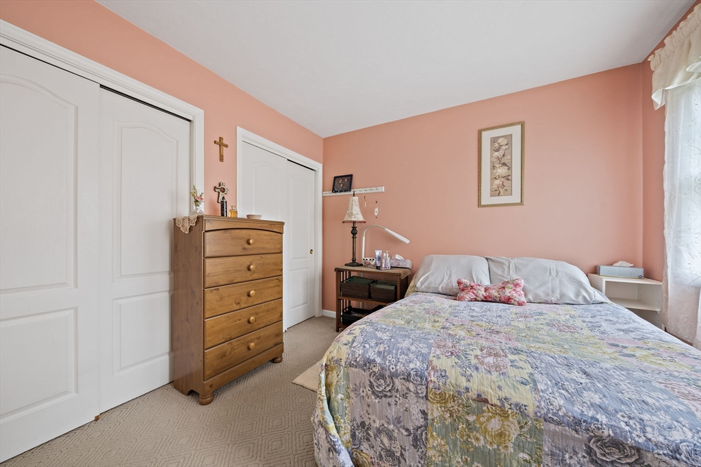 501 Auburn Street, Unit 404 Whitman, MA 02382 - Photo 14 of 35 a bedroom with a bed and a closet