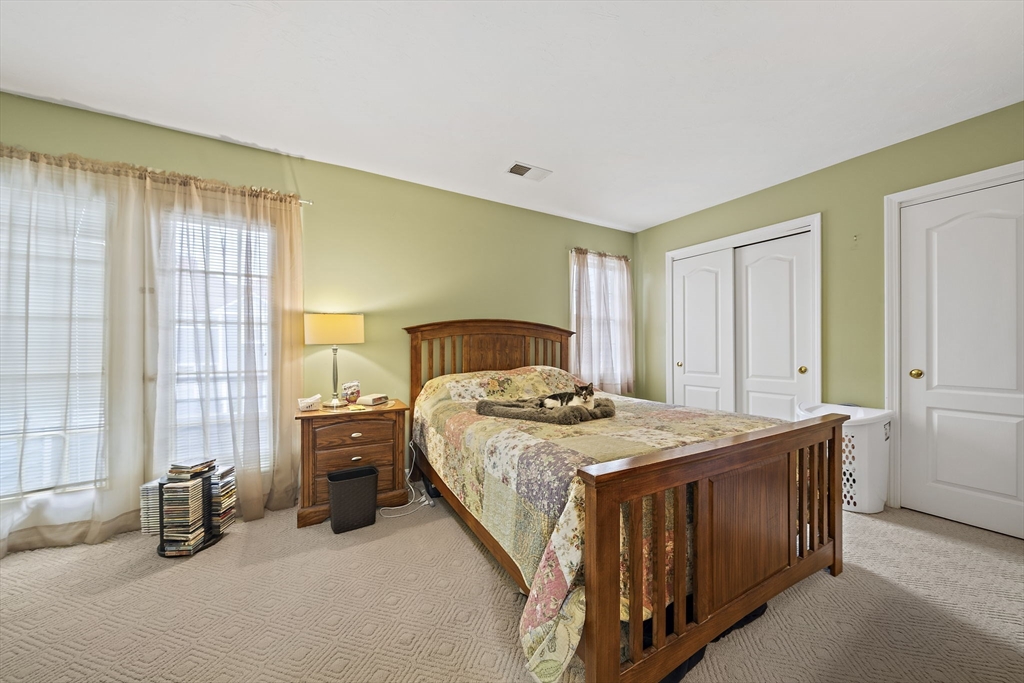 501 Auburn Street, Unit 404 Whitman, MA 02382 - Photo 15 of 35 a bedroom with a bed and a table