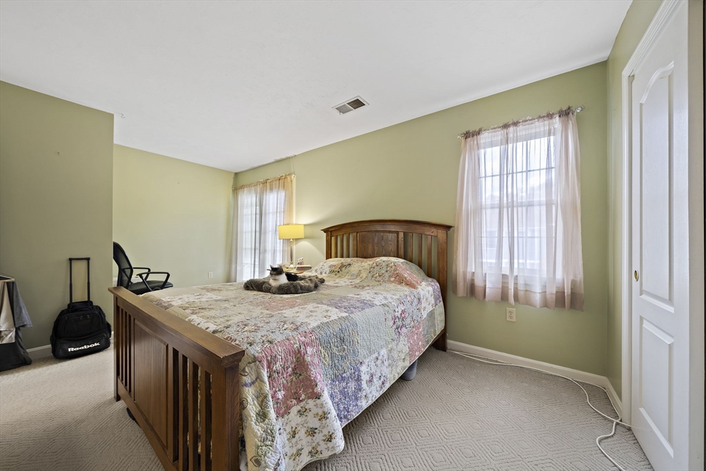501 Auburn Street, Unit 404 Whitman, MA 02382 - Photo 16 of 35 a bedroom with a bed and a window