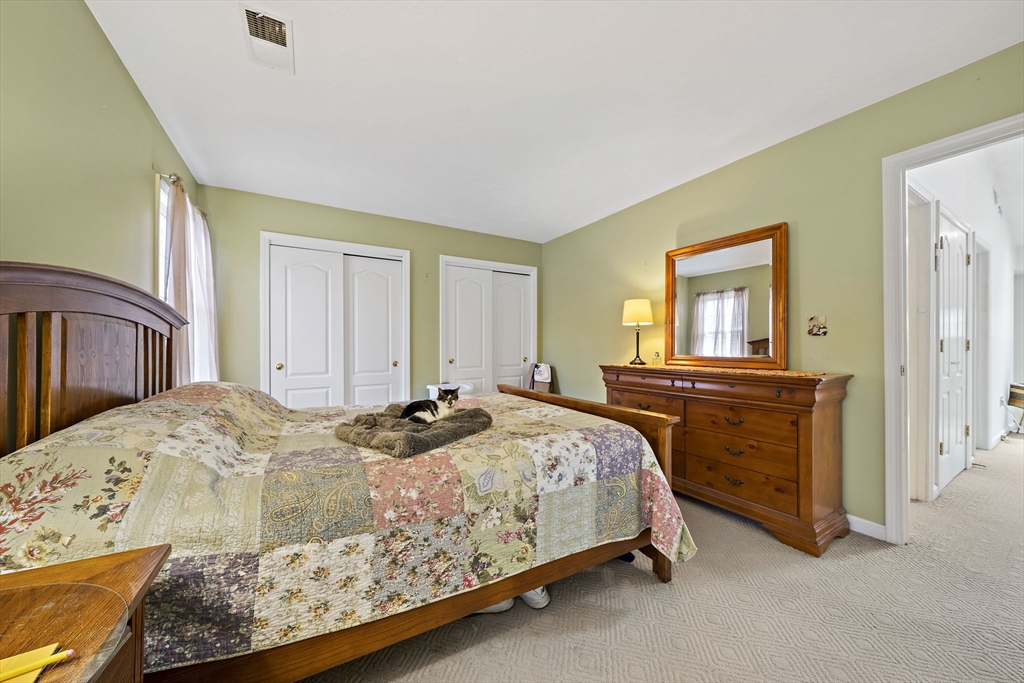 501 Auburn Street, Unit 404 Whitman, MA 02382 - Photo 17 of 35 a bedroom with a bed and a dresser