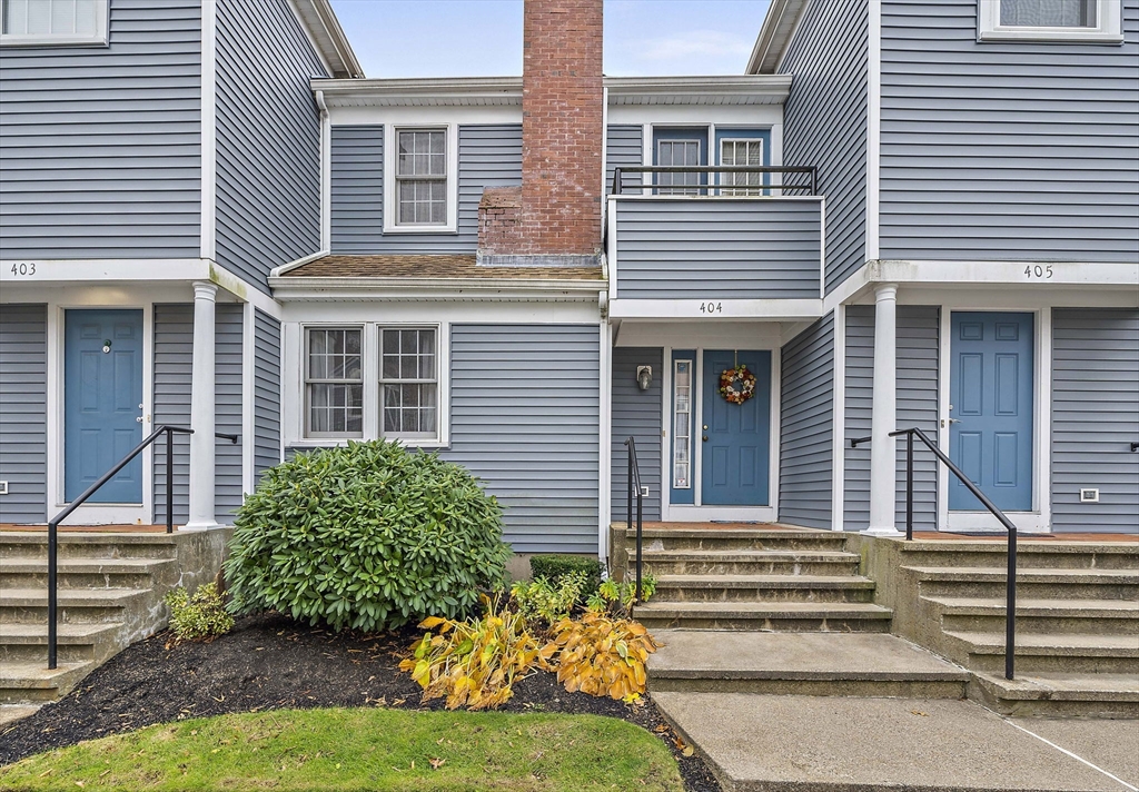 501 Auburn Street, Unit 404 Whitman, MA 02382 - Photo 2 of 35 a front view of a house with a yard