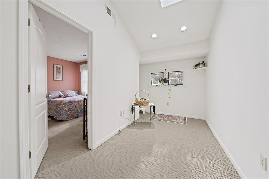 501 Auburn Street, Unit 404 Whitman, MA 02382 - Photo 21 of 35 a bedroom with a bed and a couch