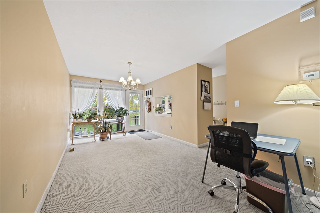 501 Auburn Street, Unit 404 Whitman, MA 02382 - Photo 22 of 35 a view of a workspace with furniture and a livingroom