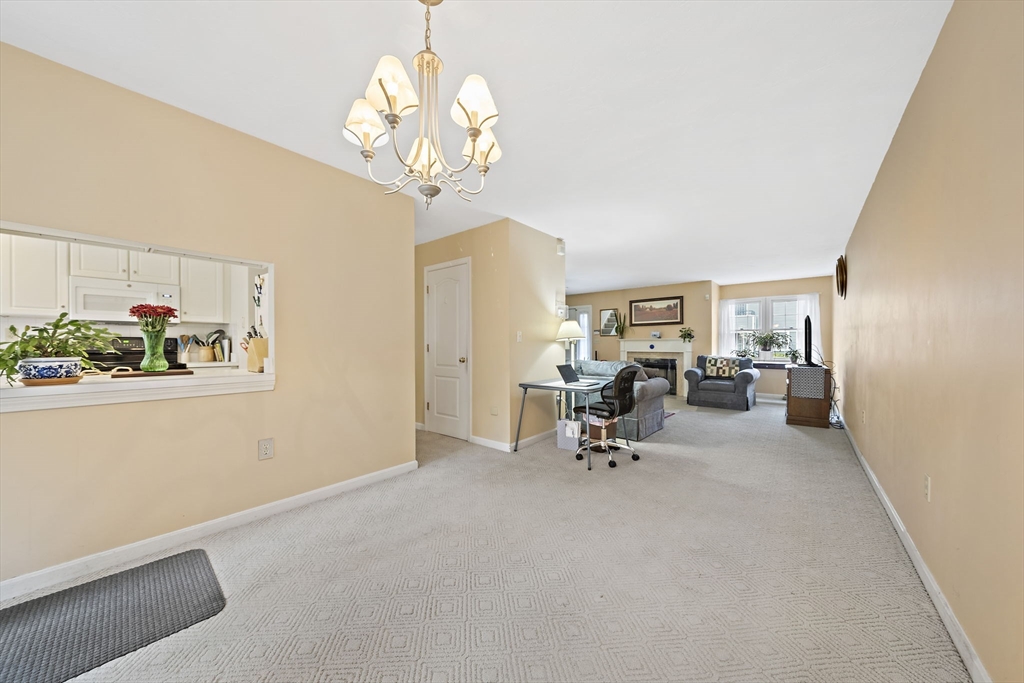 501 Auburn Street, Unit 404 Whitman, MA 02382 - Photo 24 of 35 a view of a dining room with furniture and a chandelier