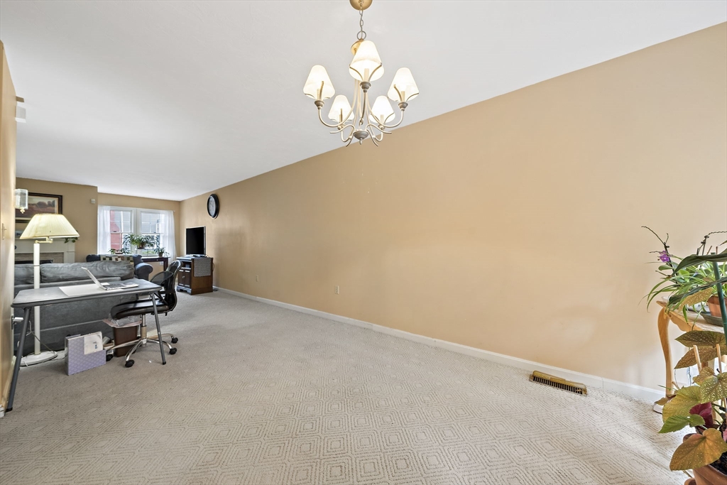 501 Auburn Street, Unit 404 Whitman, MA 02382 - Photo 25 of 35 a view of a livingroom and a dining room