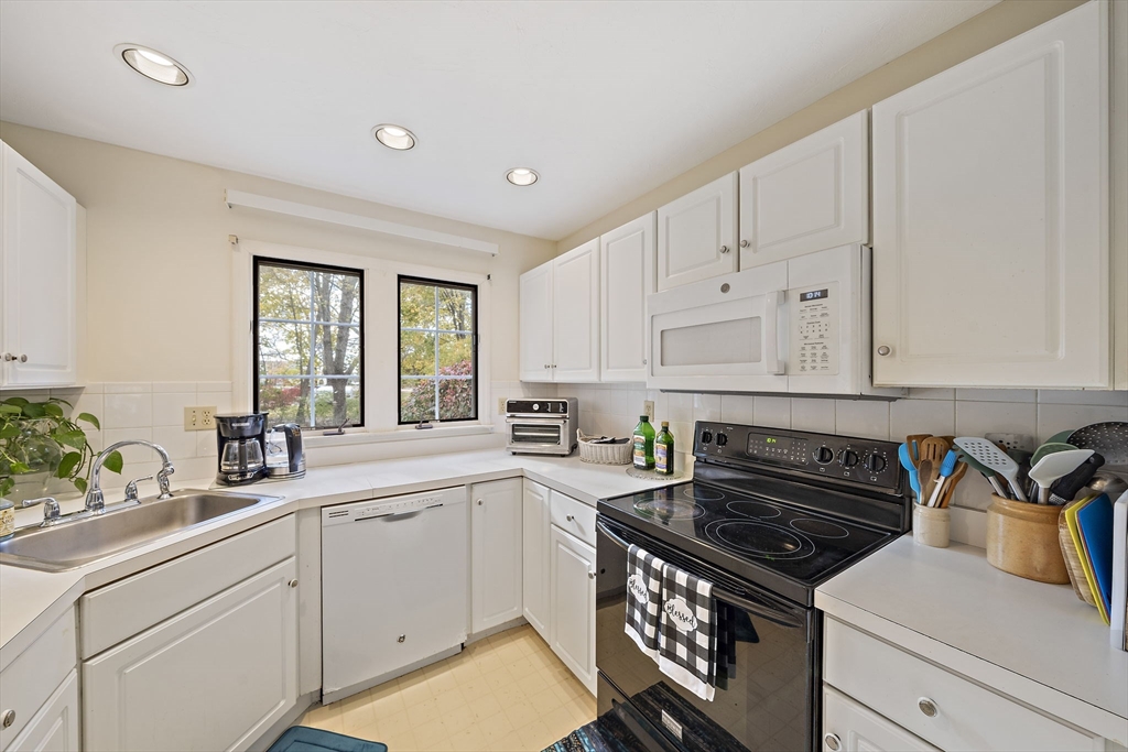501 Auburn Street, Unit 404 Whitman, MA 02382 - Photo 5 of 35 a kitchen with granite countertop a stove sink and cabinets