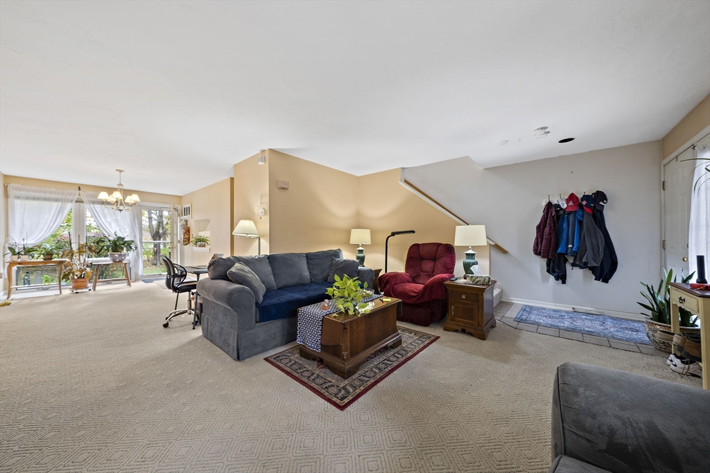 501 Auburn Street, Unit 404 Whitman, MA 02382 - Photo 9 of 35 a living room with furniture and a flat screen tv