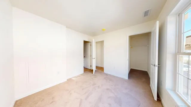 a view of a bedroom from a hallway